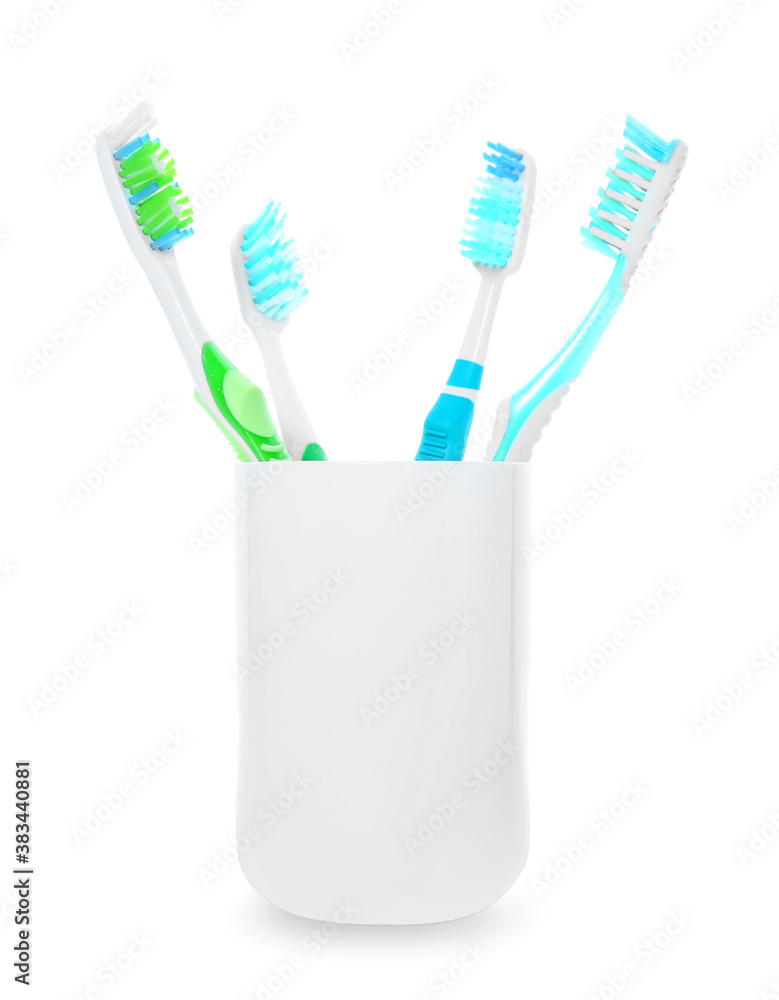 Cup with tooth brushes on white background Cup with tooth brushes on white background