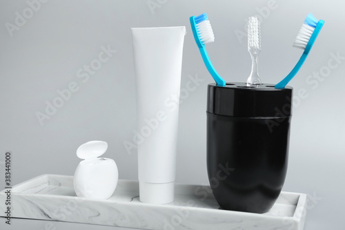 Set for oral hygiene on grey background