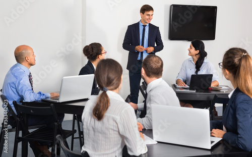 Positive smiling glad employeesin office on business meeting