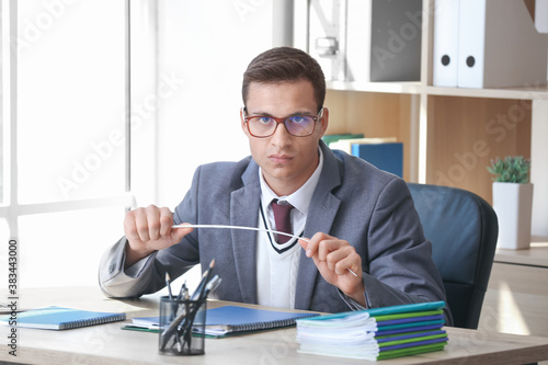Stressed young male teacher...