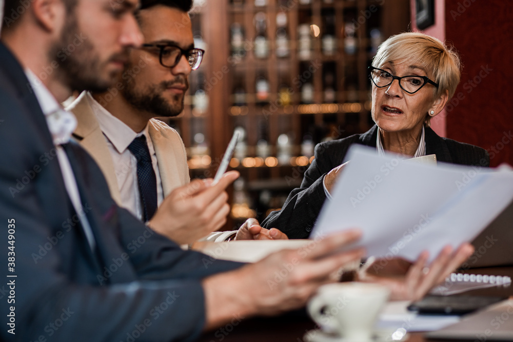 Fototapeta premium Business people holding a meeting at office cafeteria discussing about business plan.