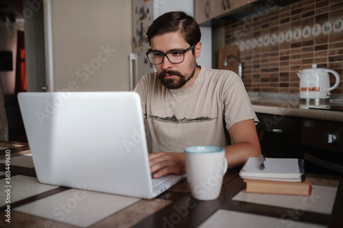 Portrait of handsome young man working in home office, copy space