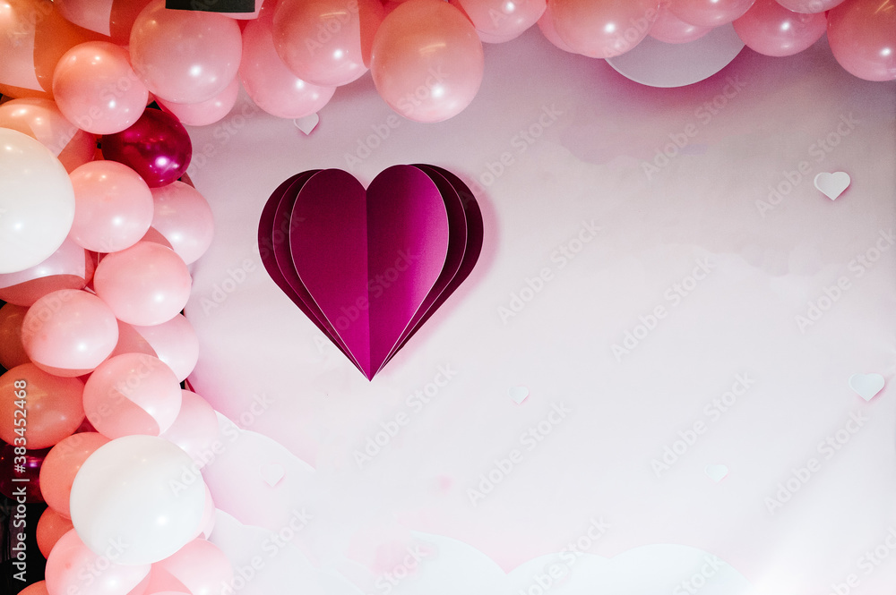 Photo-wall, wedding decoration space or place from white and pink balloons and white wall with a wedding heart. Concept of happy birthday and Valentine's day.