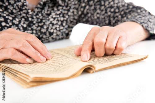Konstfotografi The old man is flipping through an old yellowed book