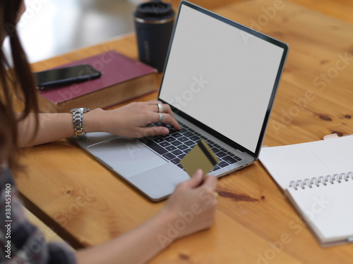 Female shopping  and online payment with credit card on mock up laptop