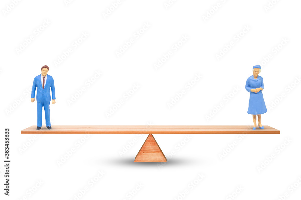 Gender Equality Concept : Male and female miniature figure people balancing on seesaw or balance scales on white background. Gender Equality Concept : Male and female miniature figure people balancing on seesaw or balance scales on white background.