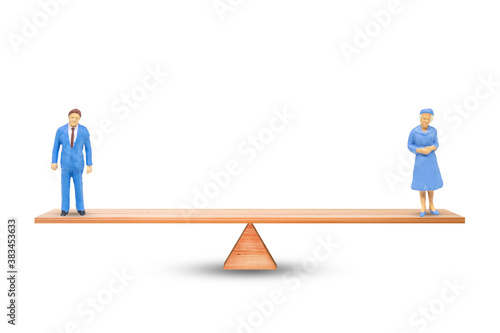 Gender Equality Concept : Male and female miniature figure people balancing on seesaw or balance scales on white background.