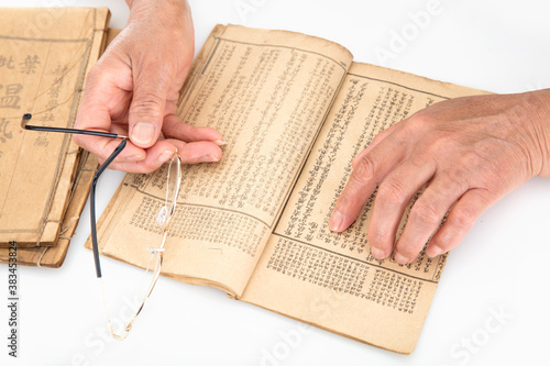 Картината върху платно The old man is flipping through an old book