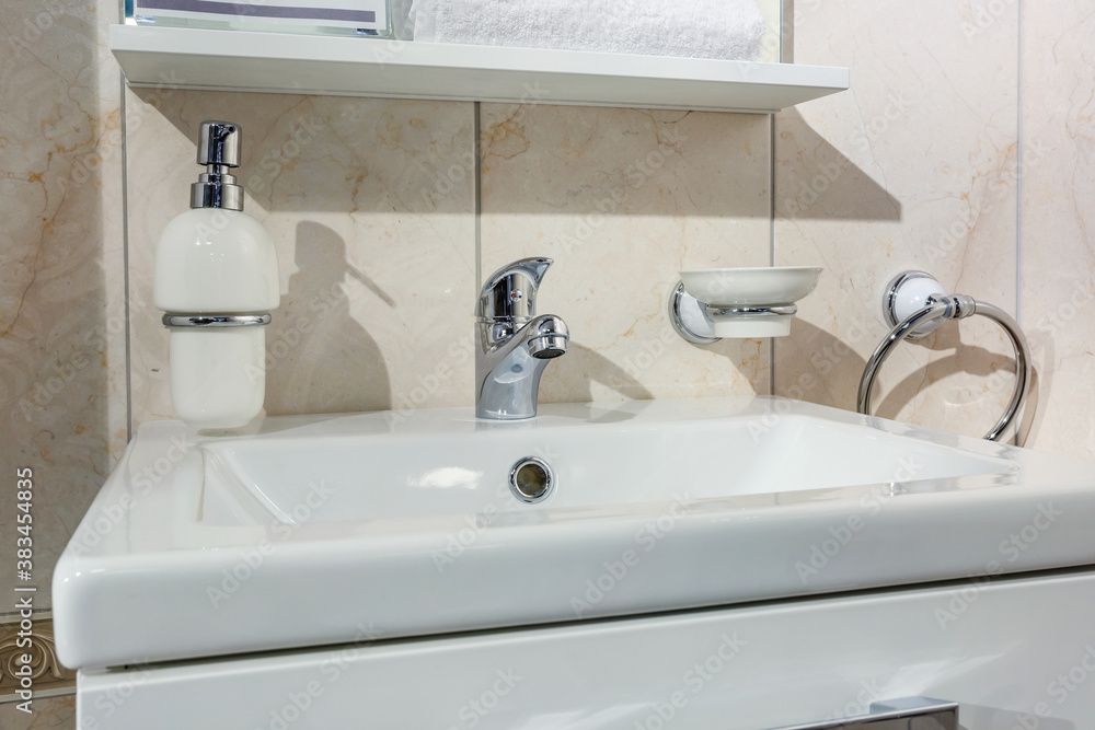 Ceramic Water tap sink with faucet with soap and shampoo dispensers in expensive loft bathroom or kitchen Ceramic Water tap sink with faucet with soap and shampoo dispensers in expensive loft bathroom or kitchen