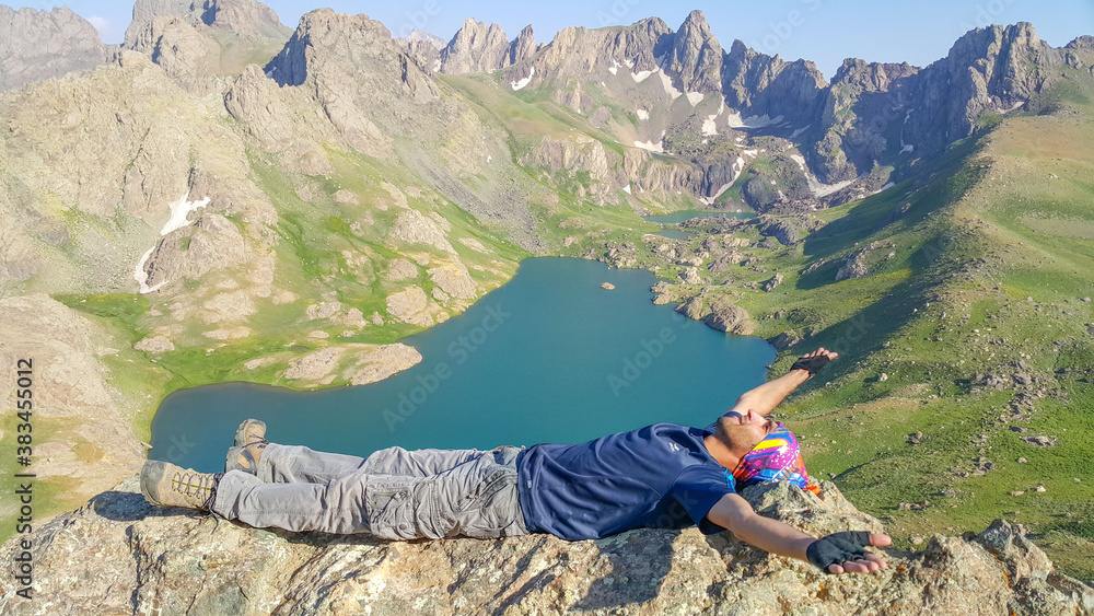 Fototapeta premium A man on the mountain top and lake view, natural landscape 