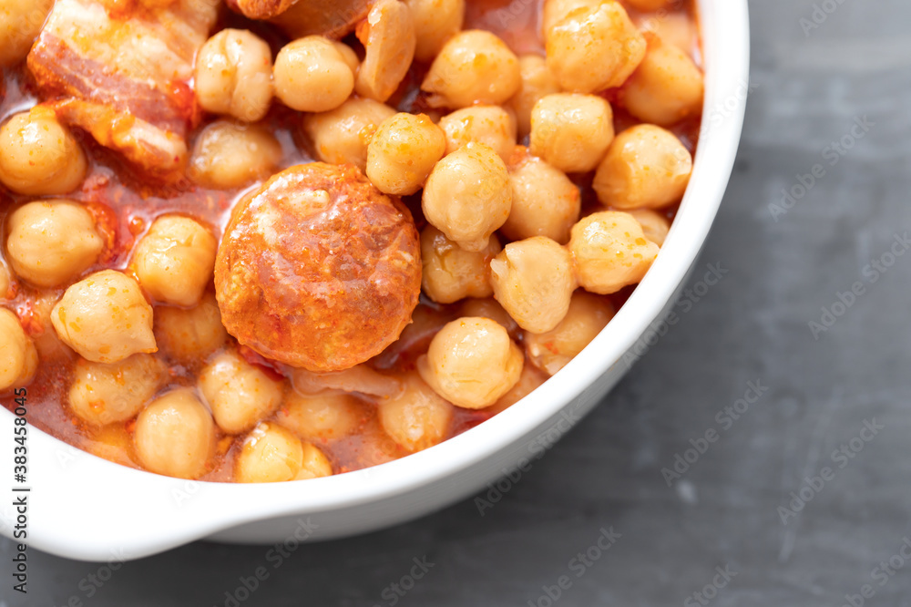 chick-pea with smoked sausage in white bowl chick-pea with smoked sausage in white bowl