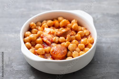 chick-pea with smoked sausage in white bowl