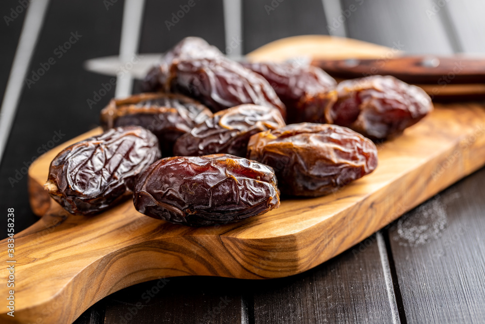 Dried dates fruit on cutting board. Dried dates fruit on cutting board.