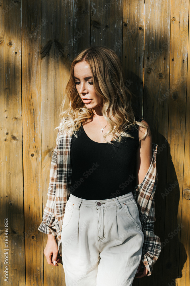Fototapeta premium Portrait of an adult beautiful woman on a bright autumn yellow background. Unusual sun shade.