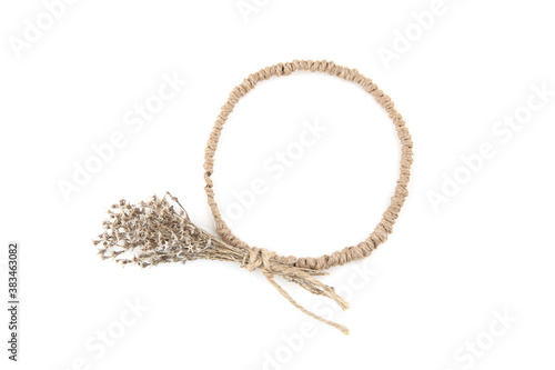 Circle frame of jute with dried grasses moss isolated on white background. Wild herbs or flowers decorations, diy concept.