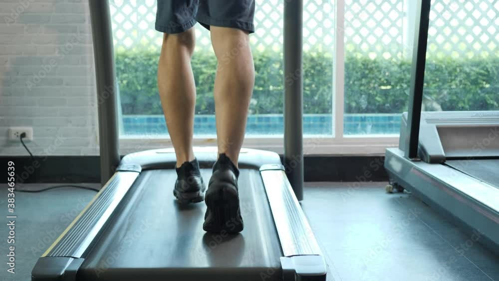 Bottom view Man exercise on treadmill cardio running workout at fitness gym healthy lifestyle. Slow motion Bottom view Man exercise on treadmill cardio running workout at fitness gym healthy lifestyle. Slow motion