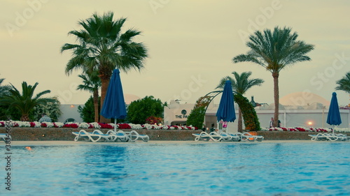 Beautiful swimming pool at hurghada resort in summer evening. Open air lido.