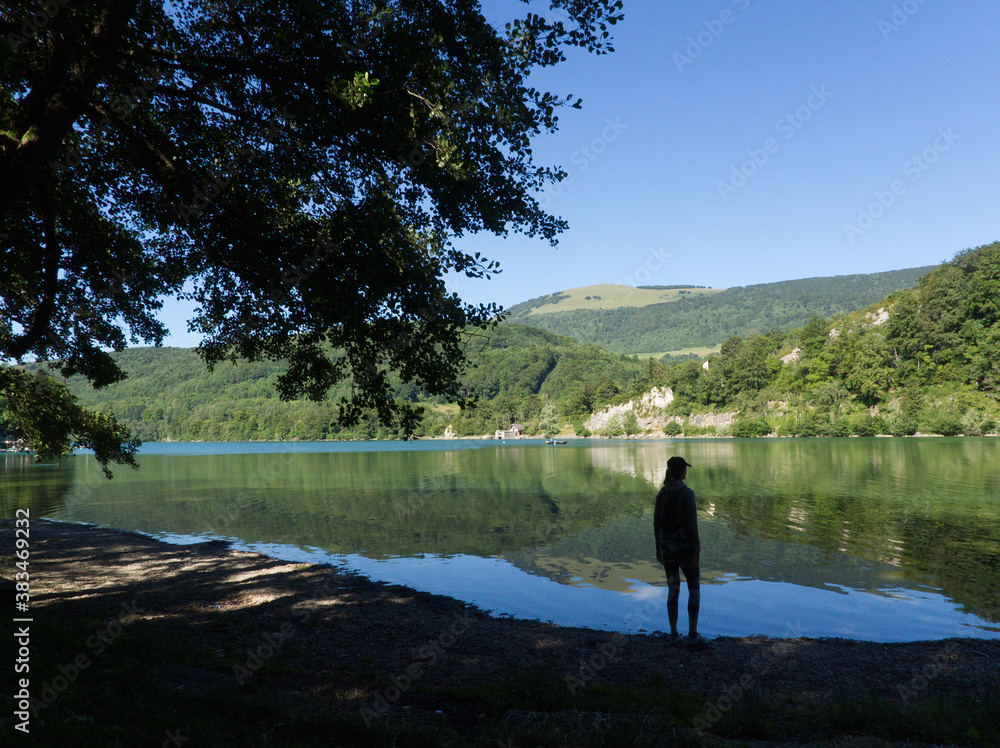 Nice reflection on the water of the lake in Laffrey with a woman figure