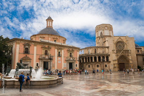 Valencia, Spain -  07/24/2019: Basílica de la Virgen de los Desamparados and Valencia Cathedral. La Seu de Valencia on La Plaza De La Virgen - St. Mary Square. Editorial use only.