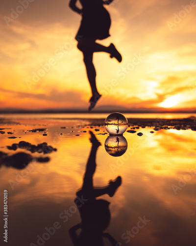 Fototapeta Naklejka Na Ścianę i Meble -  Lensball and jumping girl