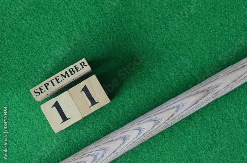 September 11, Number cube with a snooker stick on a green background, snooker table.