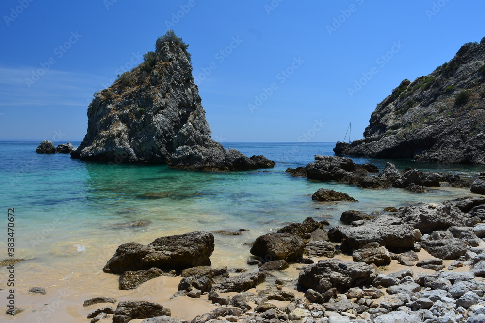Transparent water beach near the rocks area in Sesimbra, Portugal