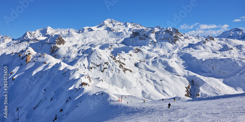 Panoramic view of the mountain range behind ski slope near Tignes high-altitude ski resort in France during the winter season. © thecolorpixels