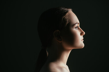Face contouring. Aesthetic cosmetology. Profile portrait of confident woman isolated on black copy space background. Skincare wellness. Lip augmentation.