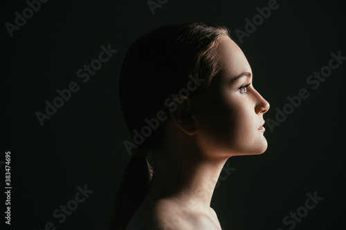 Face contouring. Aesthetic cosmetology. Profile portrait of confident woman isolated on black copy space background. Skincare wellness. Lip augmentation.
