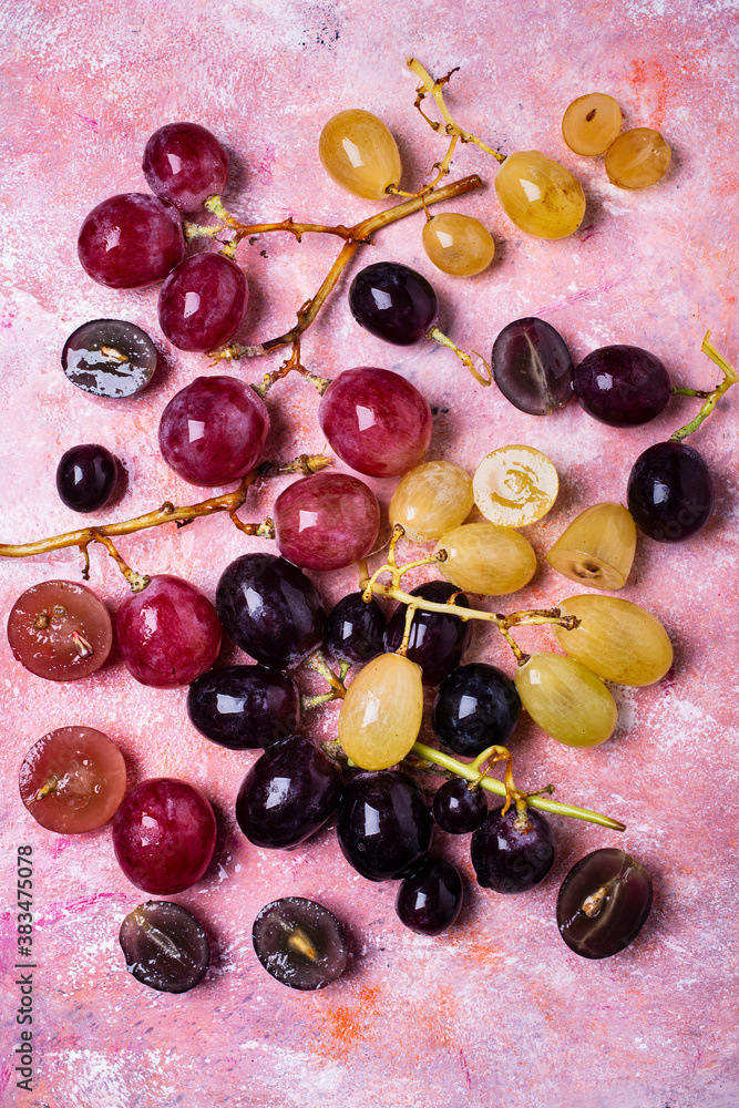 Fresh red, white and black grapes on a textured background Fresh red, white and black grapes on a textured background