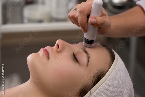Rejuvenating facial treatment. Model getting lifting therapy massage in a beauty SPA salon.