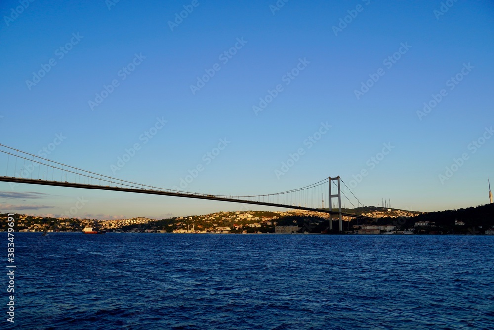Tourist boats sail under the bridge in Istanbul. Traveling on the Bosphorus. Panoramic view, View of the First Bosphorus Bridge sailling Bosporus. Tourist boats sail under the bridge in Istanbul. Traveling on the Bosphorus. Panoramic view, View of the First Bosphorus Bridge sailling Bosporus.