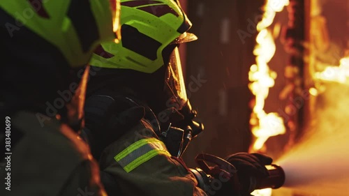 Fireman extinguish fire with the hose. Burning house fire drill. High quality 4k footage
