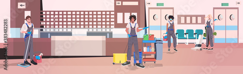 professional cleaners team mix race janitors with cleaning equipment working together hospital corridor interior full length horizontal vector illustration