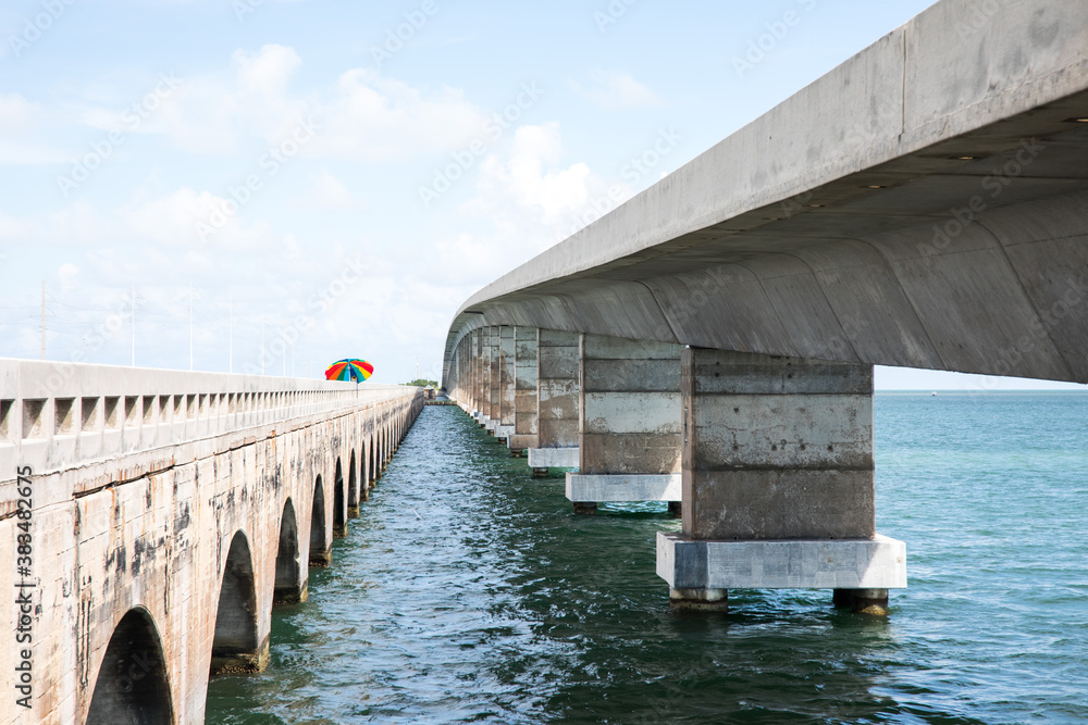 Concrete bridge over blue ocean water