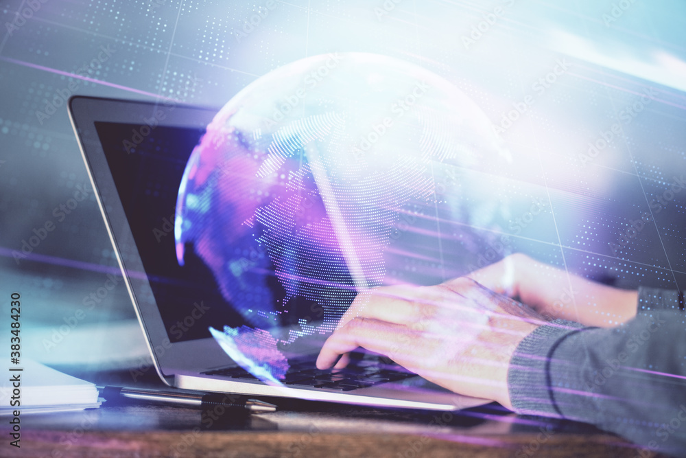Fototapeta premium Technology theme hologram with man working on computer on background. High tech concept. Double exposure.