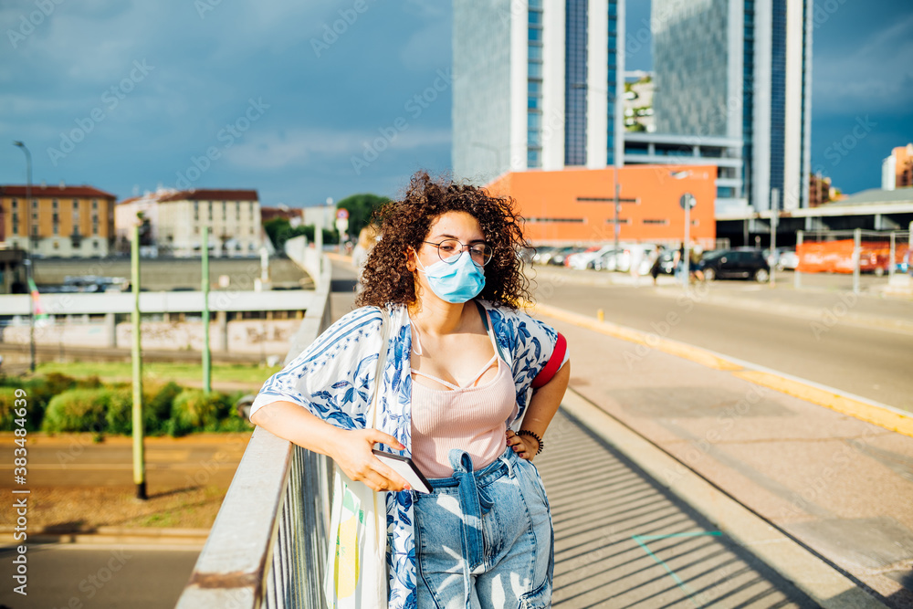 Young mixed race woman wearing mask posing outdoor - Multiethnic girl outdoor wearing anti smog mask