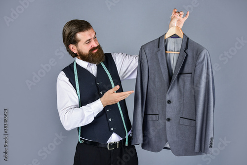 confident tailor designing male jacket. handsome sartor with tape measure. male beauty and fashion. bearded man tailoring clothes. formal and office wardrobe. businessman