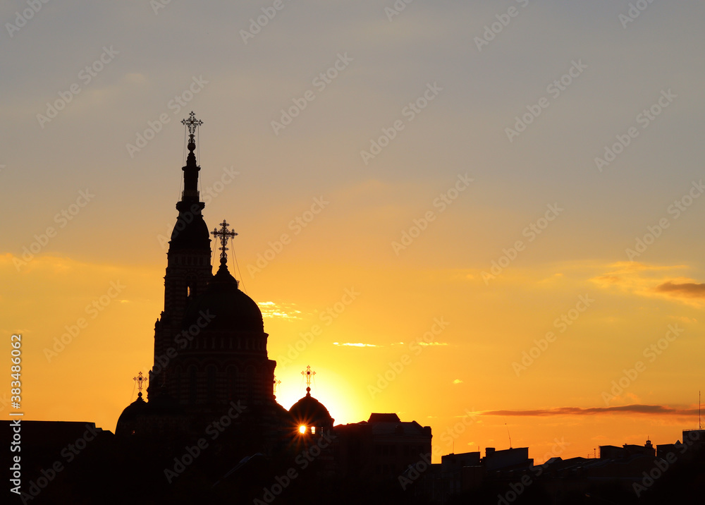 image of a christian temple against a sunset sky