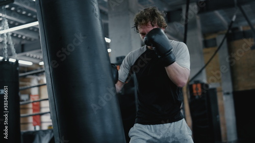 Ambitious fighter training in fitness center. Kickboxer warming up at gym © stockbusters
