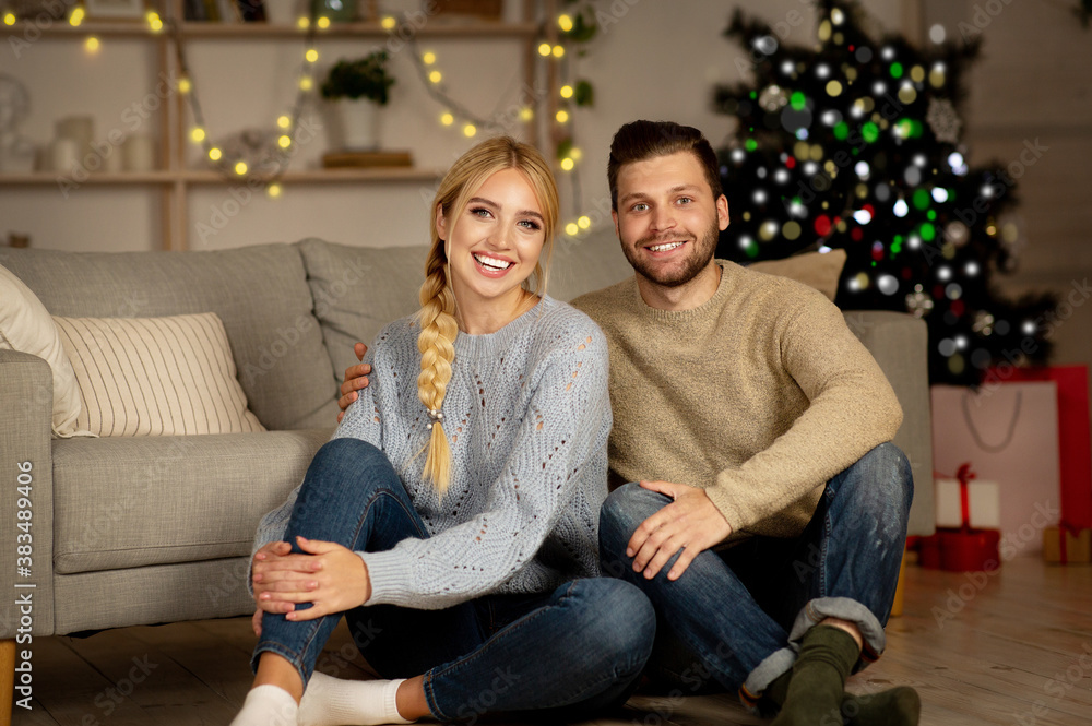Beautiful young couple celebrating Christmas together at home Beautiful young couple celebrating Christmas together at home