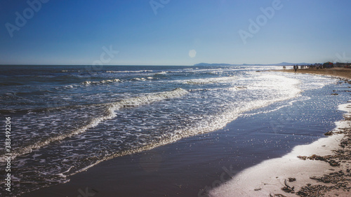 Sandy beach of the Adriatic Sea in calm, clear weather. Rimini, Italy