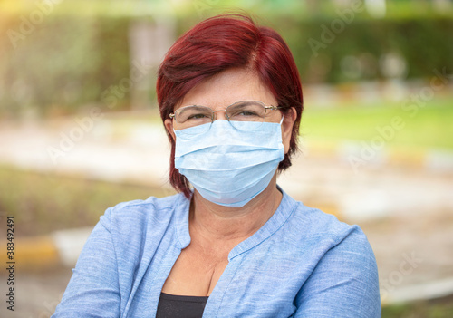 Portrait of mature woman with protective mask.