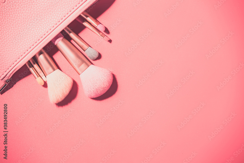 Make up brushes with powder on pink background Make up brushes with powder on pink background