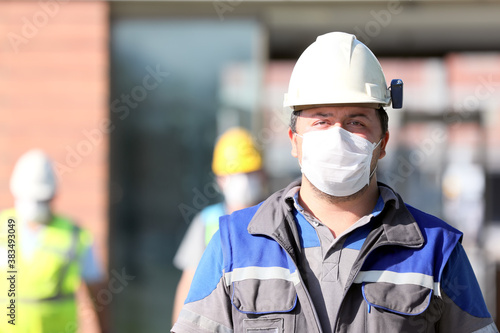 The worker is using personal protective equipments. For healthcare professionals caring for people with covid-19, the CDC recommends placing the person in an airborne infection isolation room.