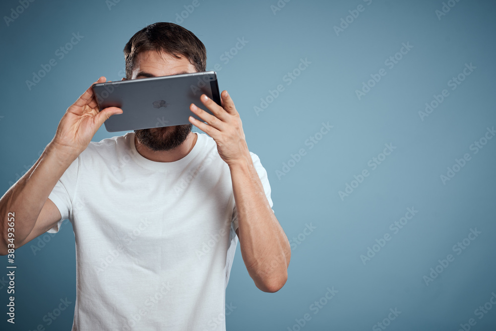 man with tablet near face on blue background cropped view touch monitor new technologies Copy Space man with tablet near face on blue background cropped view touch monitor new technologies Copy Space