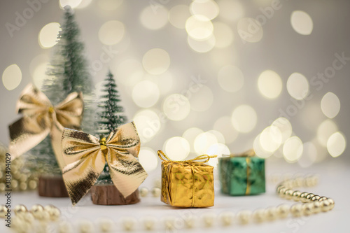 Two Christmas trees decorated and gifts for the new year on the bokeh background, new year mood 2021