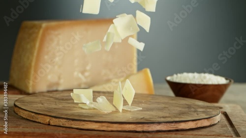 Super Slow Motion Shot of Parmesan Shavings Falling on Wooden Board at 1000 fps. photo