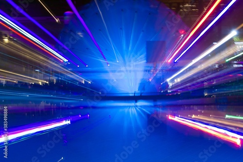 motion blur of multicolor open air disco lights at the pool
