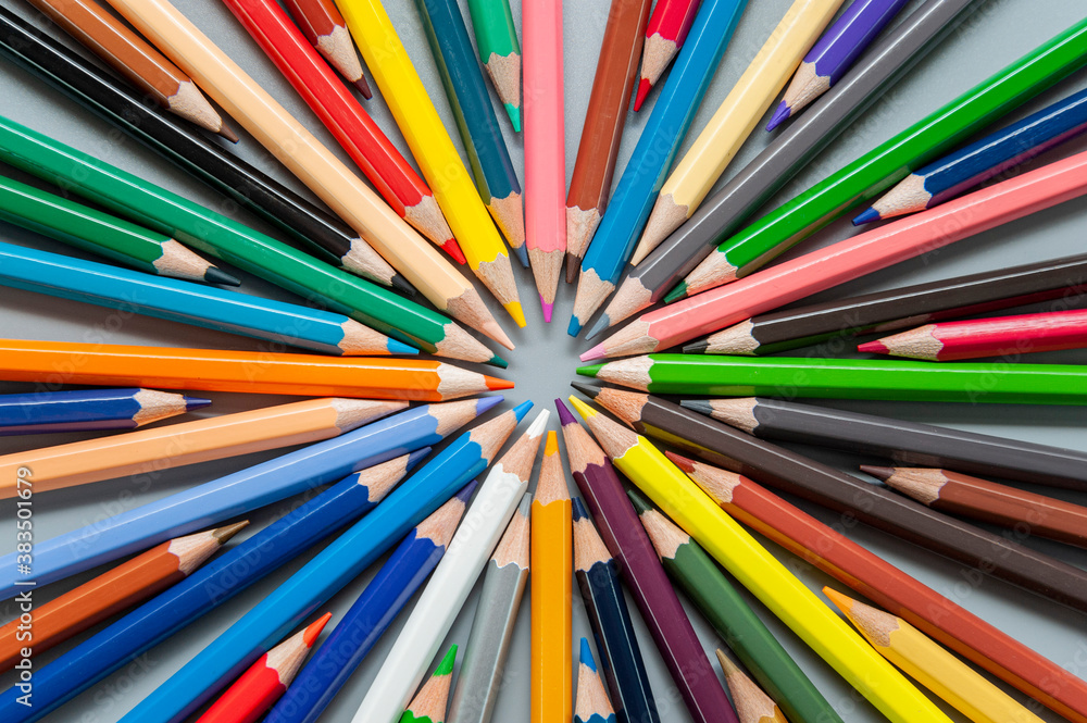 Multi-colored pencils are arranged in a circle in the form of rays Multi-colored pencils are arranged in a circle in the form of rays